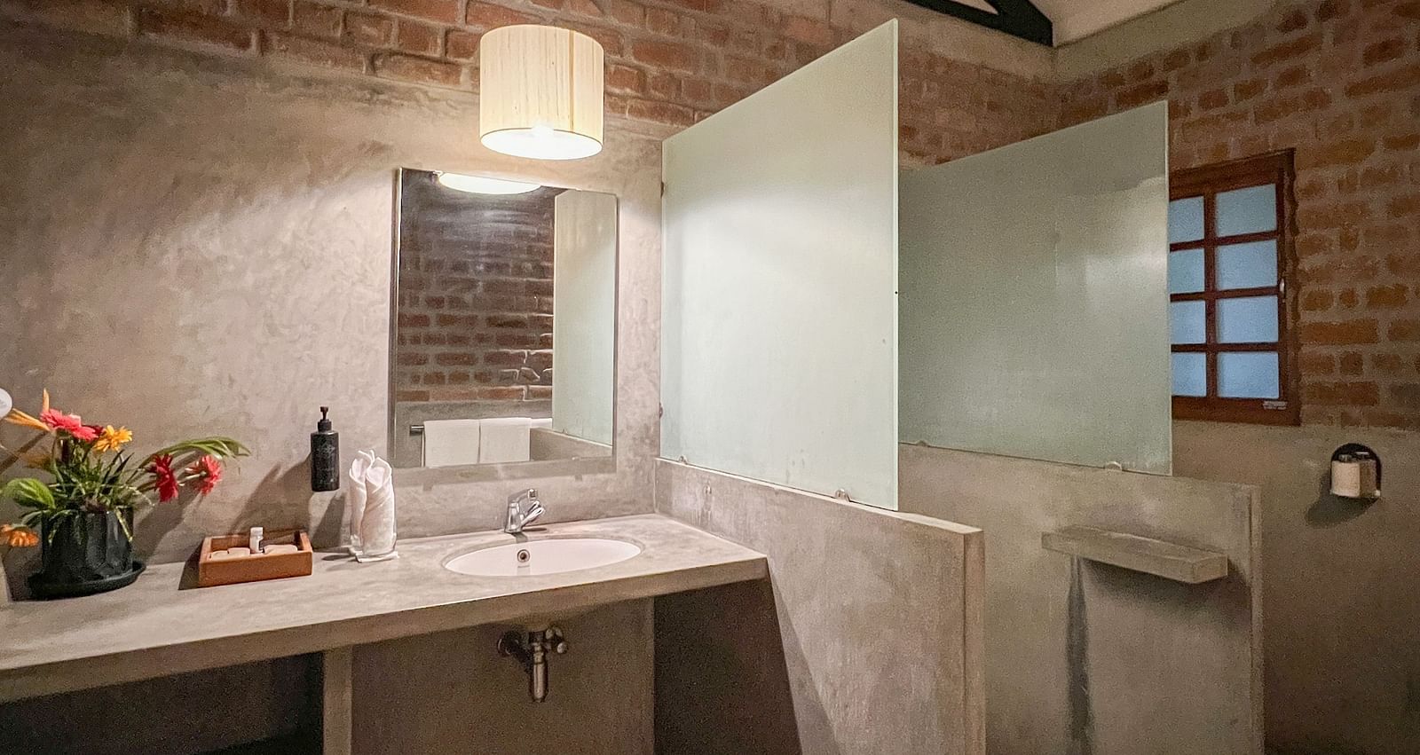 Swiss Chalet Washroom with showering area separated and a table alongside it.