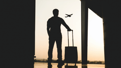 A man holding his luggage at the airport