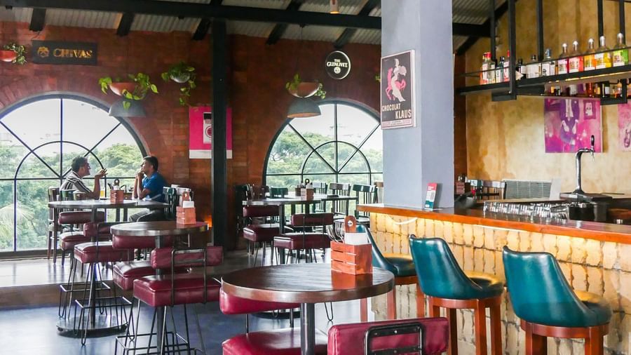 A lively hotel bar area with modern seating and a unique ceiling design, perfect for socialising at Shilton Dee Cee.