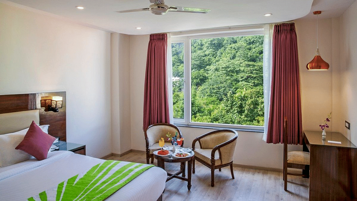 The brightly lit Premium Room with ample of natural light coming from the window at Regenta Inn DLS.