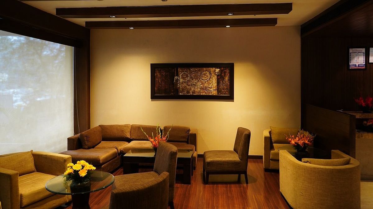 comfy sofa placed in the lounge area of Shervani Nehru Place, New Delhi