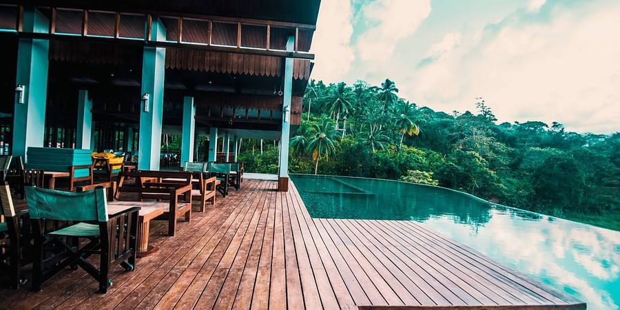 The deck by the infinity pool at the sunset lounge - Symphony Samudra Beachside Jungle Resort And Spa, Port Blair
