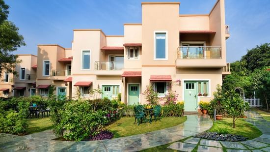 A facade image of the villas surrounded by greenery - Karma Lakelands.