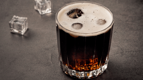 a glass of whiskey kept on a table