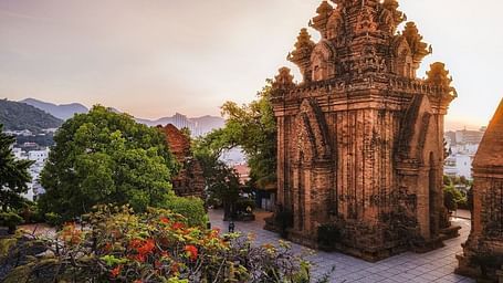 An image of a monumental structure and some bushes near - Alibu Resort Nha Thrang