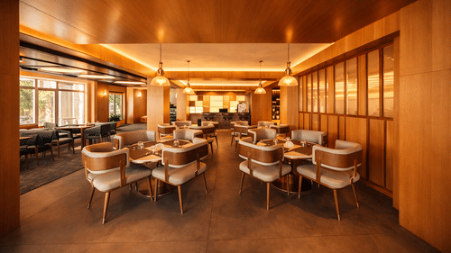 A large restaurant space with multiple tables, chairs, and wooden panelled walls | Pride Premier Darjeeling