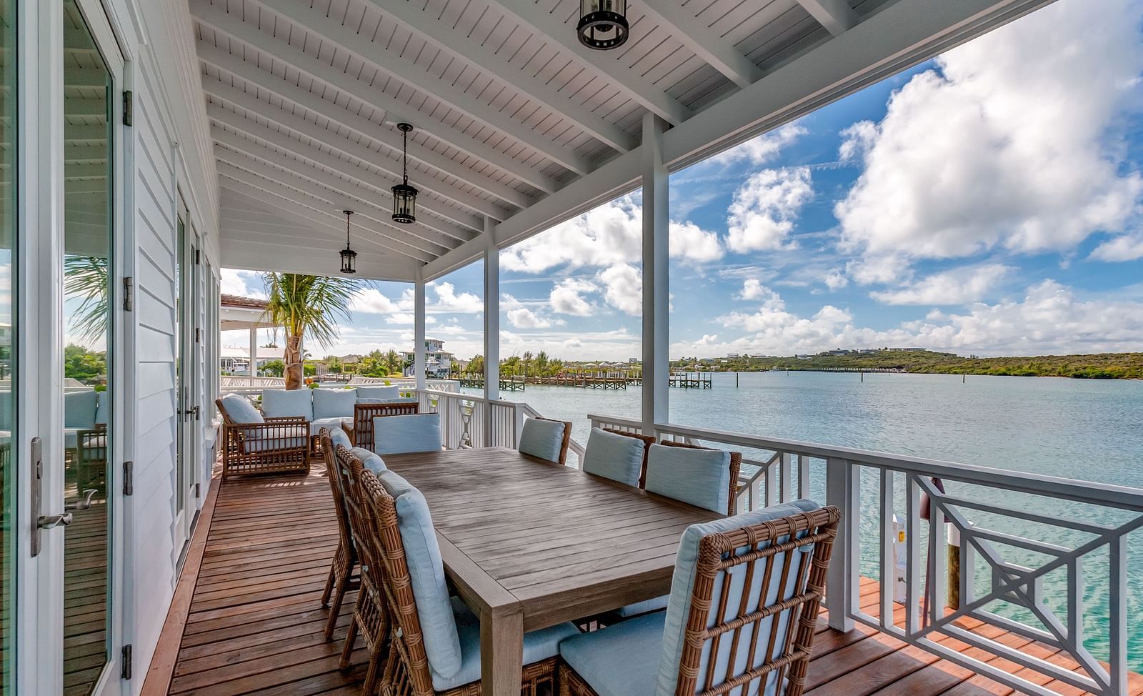 Outdoor dining space on a covered porch with ocean views | Abaco Inn