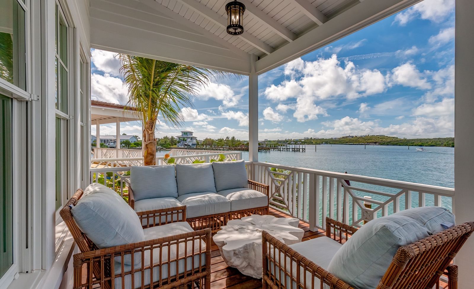 Covered balcony with plush seating and sea views | Abaco Inn