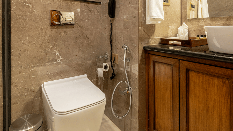 a bathroom featuring a commode right besides the vanity area - Brij Castle, Jaipur