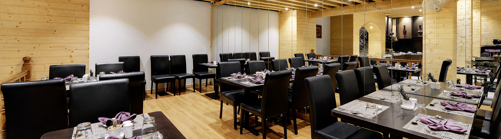 overview of the seating arrangements inside blue charcoal Restaurant - Sumitel Shangrila, Deorali