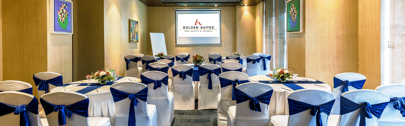 Senate 1 banquet hall with a decorated chair and screen presenter