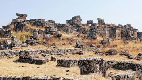 A view from far out of an old ruins with many rocks and boulders in view - Gwalior Tourist Places.