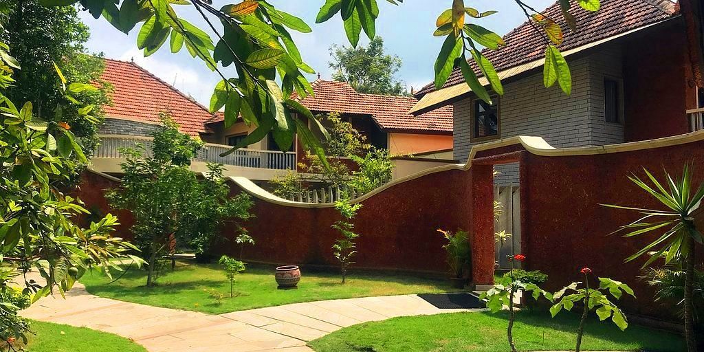 facade image of the luxury jucuzzi villas nestled amidst lush greenery at hoysala village resort in hassan