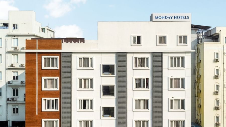 Facade of Destino by Monday Hotels featuring a multi-storey building under a partly cloudy sky.