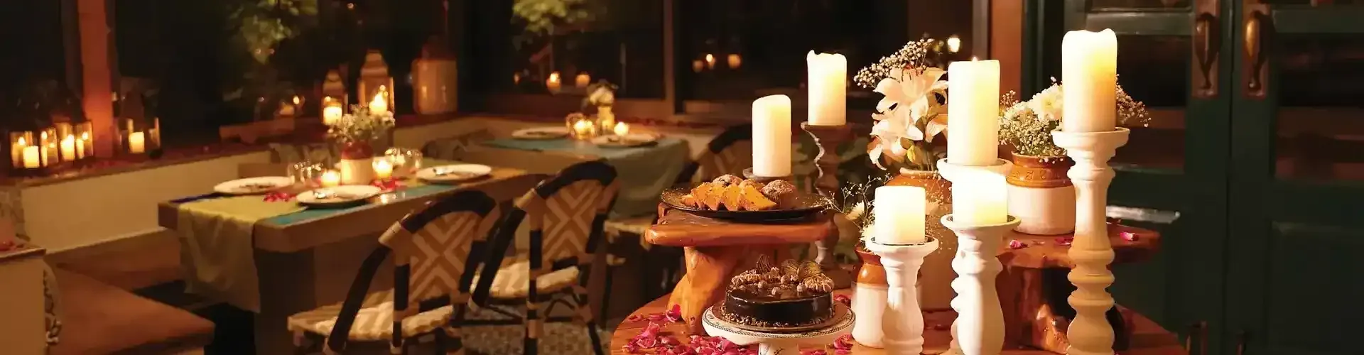 Dining area with candle lit tables and chairs.