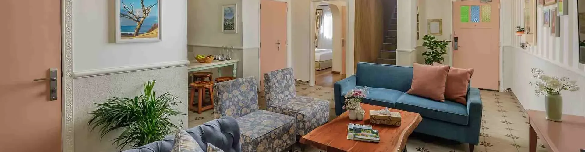 Indoor lounge with armchairs, sofas, and wall art at Karma Chalets.