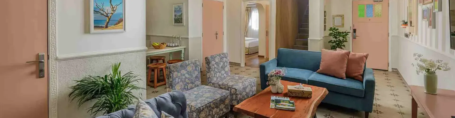 Indoor lounge with armchairs, sofas, and wall art at Karma Chalets.