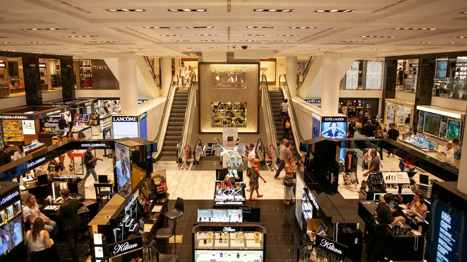 An overview of a busy shopping mall with many people in view.