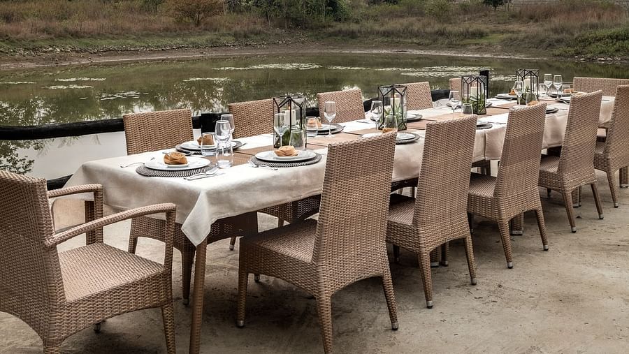 Evening view of the dining table near Swimming Pool at Saccharum Safari Lodge, Balaghat