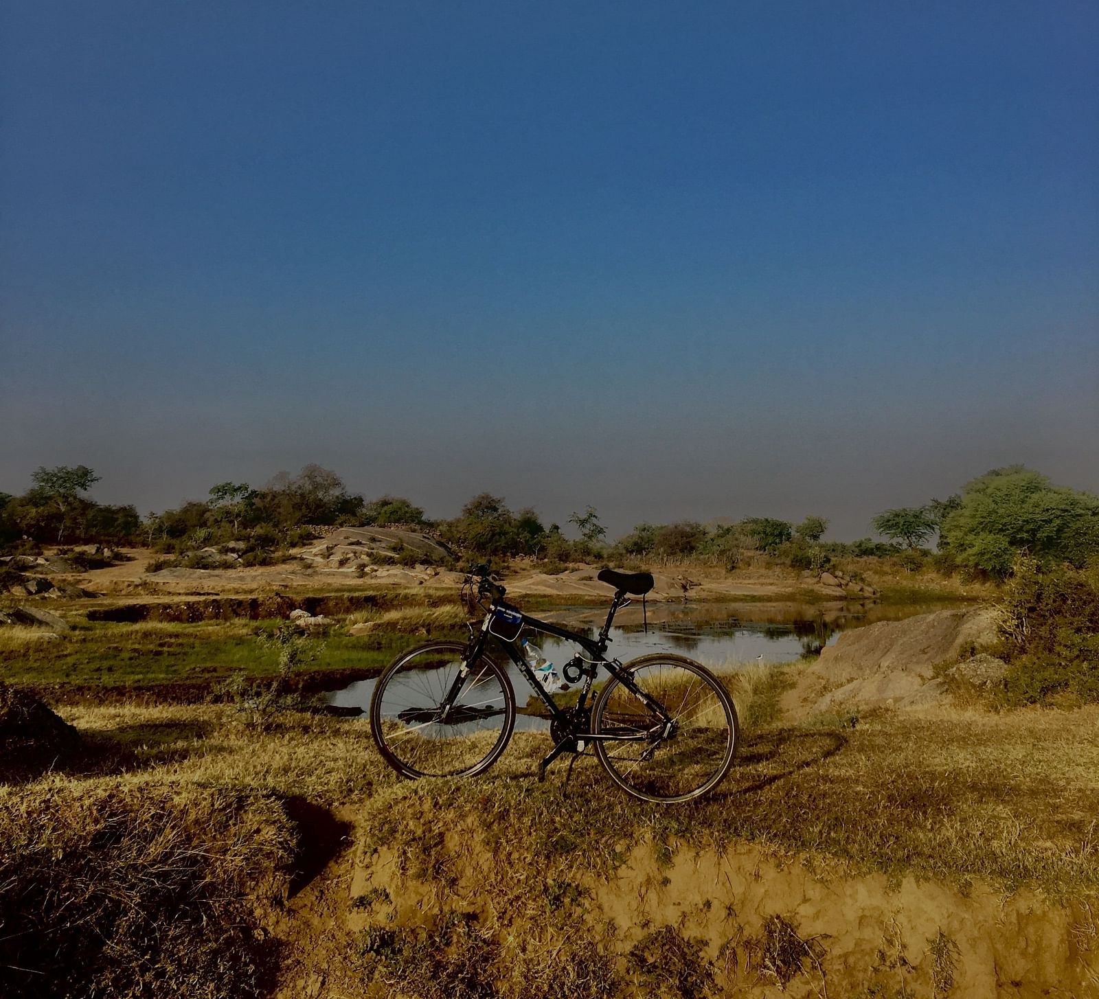 image of a cycle parked in an open grassland