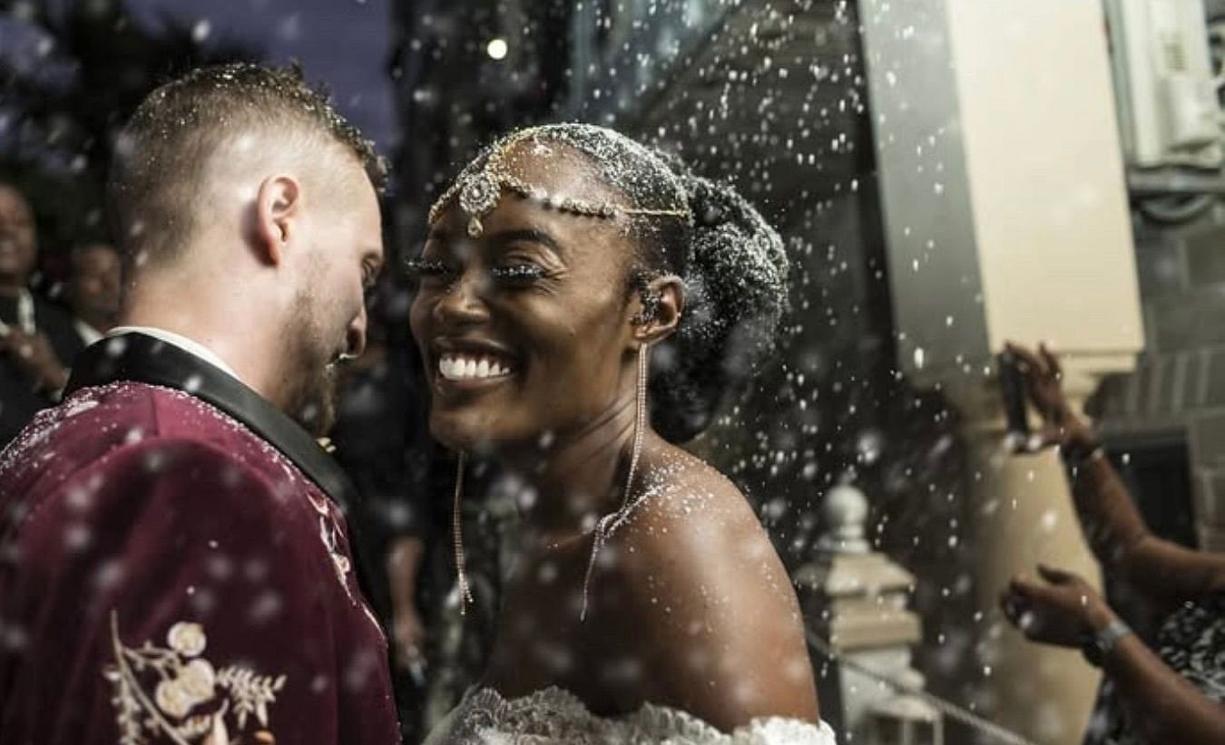 A couple smiling during wedding celebration with confetti in the air | A Stone's Throw Away
