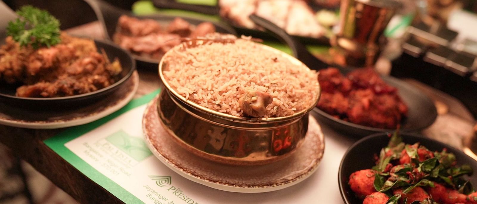 An image of chicken biryani with chiecken gravy and fry - Pai Group of Hotels