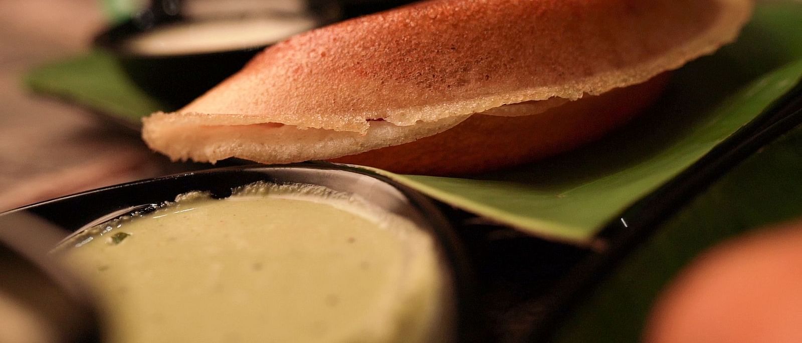 An image of dosa served with curd and pickle - Pai Group of Hotels