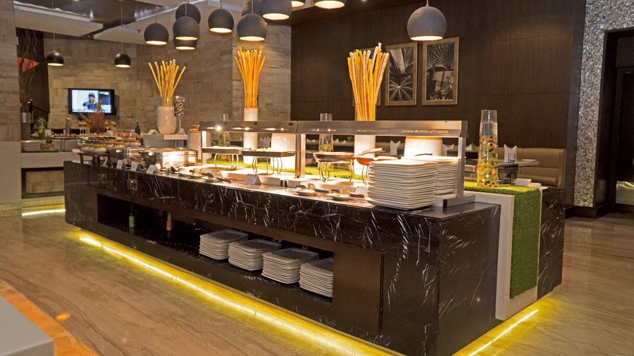 Modern buffet restaurant with live counters and seating at Park Plaza, Ludhiana.