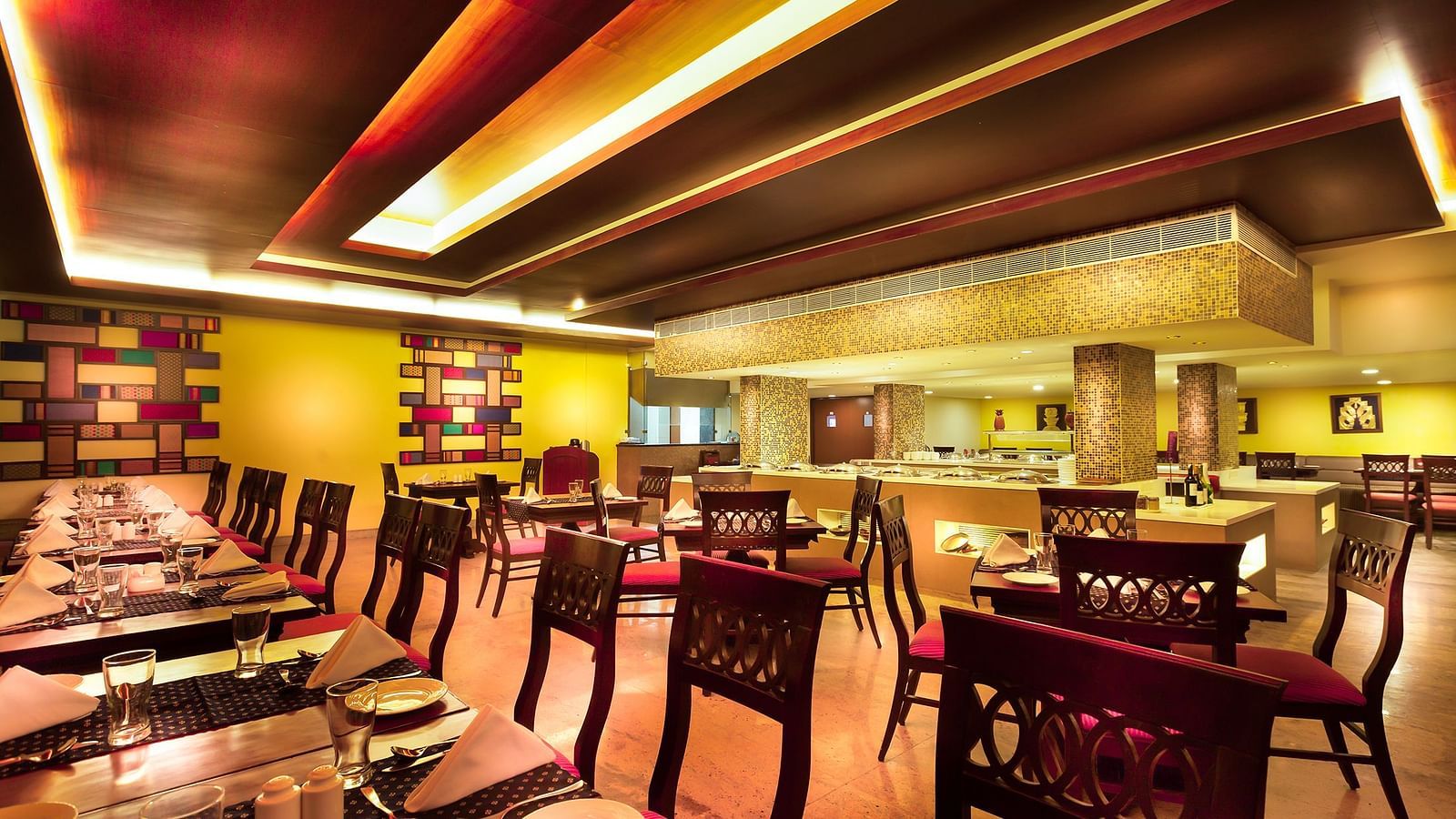 An image of a dining space with tables and chairs at Regency Madurai by GRT Hotels