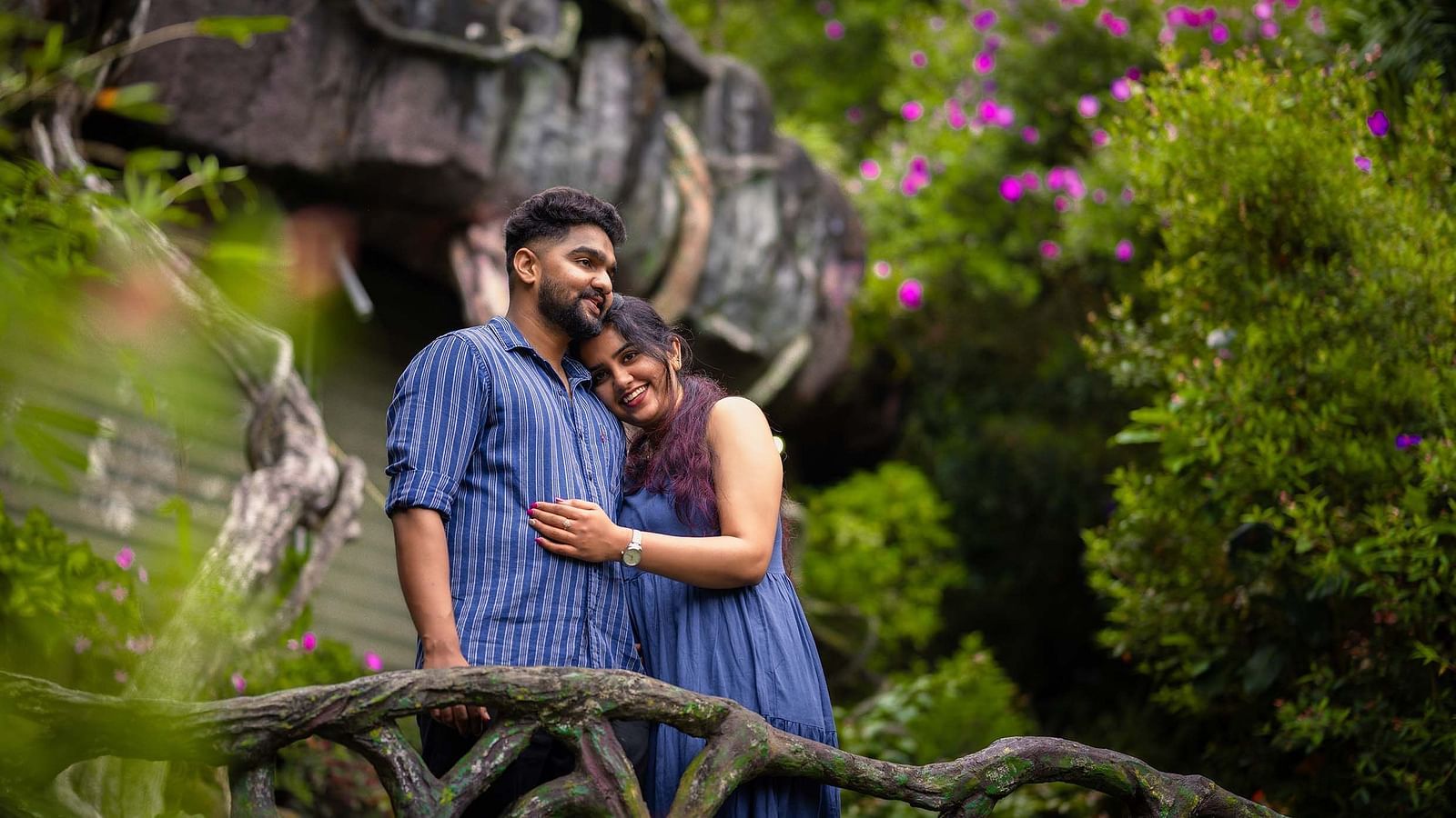 a couple in a scenic place with greenary and violet flowers