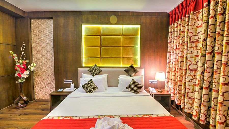 suite with a comfy king size bed and wooden flooring