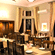 Hotel Devnadi, Haridwar | A dining space with chairs, tables, and a fan.