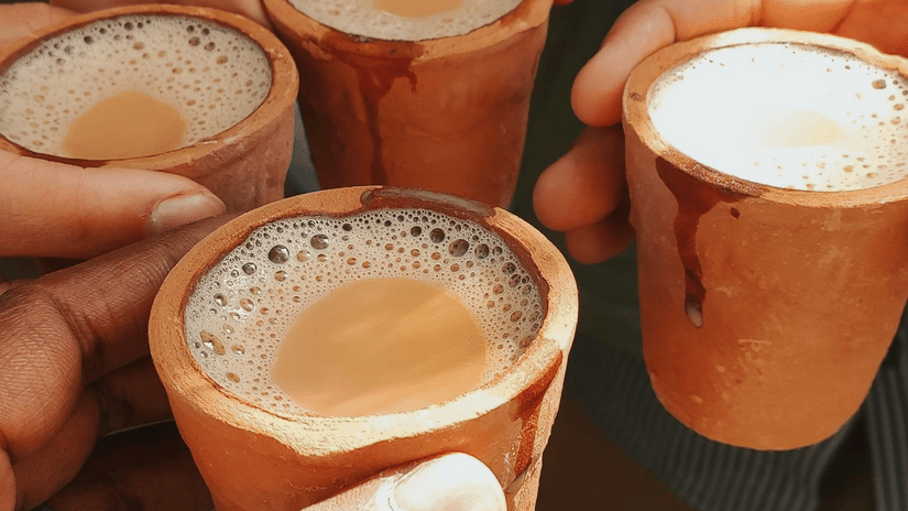 People holding kulhad cups with tea in them together