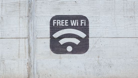 The words 'Free Wi-Fi' painted on a wall with the network symbol.