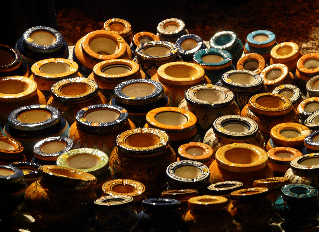 Pots of various sizes clustered together, glowing softly under the light.