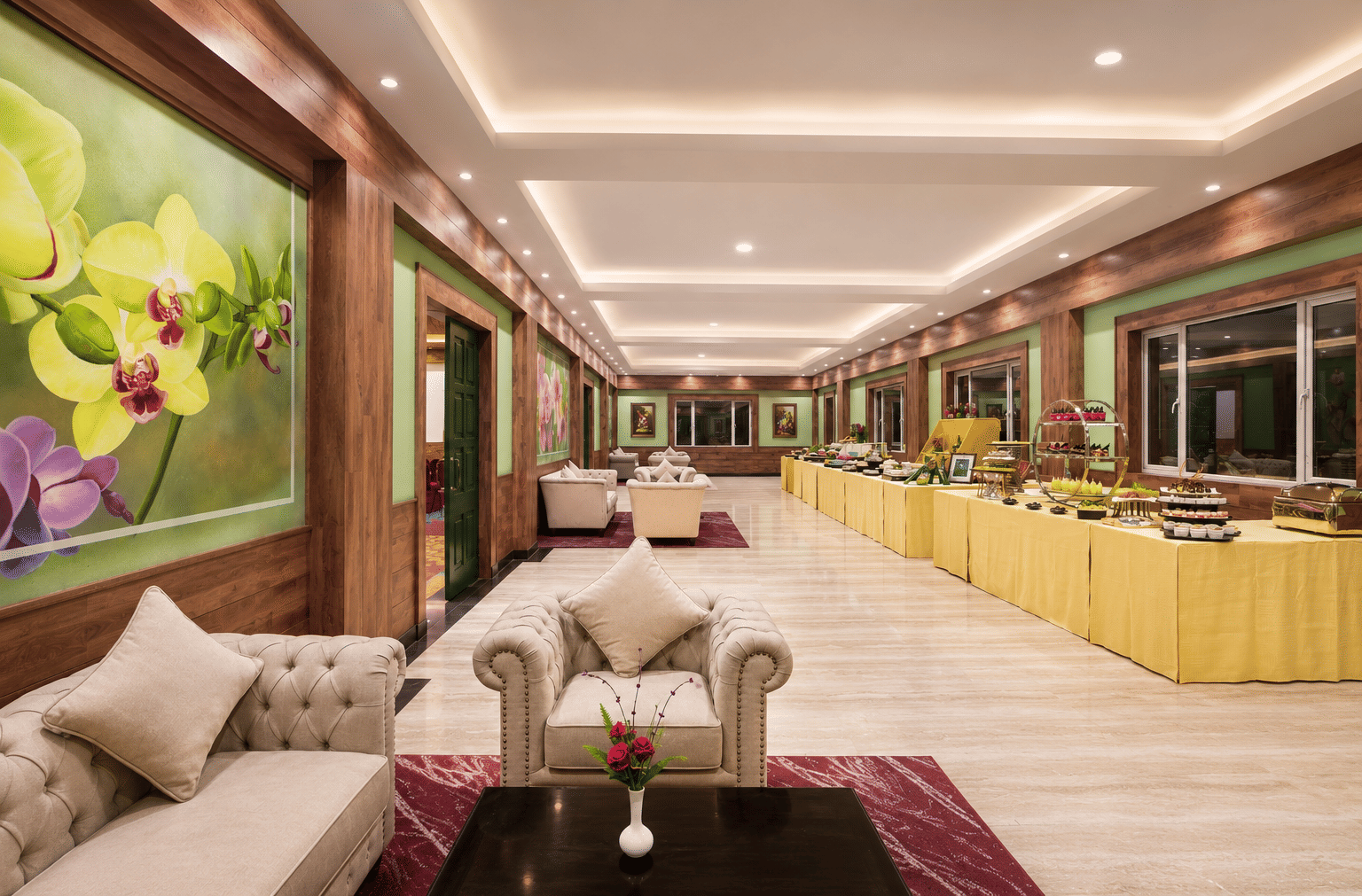 Everest pre-function area with Chesterfield lounge seating, orchid wall murals and draped buffet counters at MAYFAIR Himalayan Spa Resort, Kalimpong.