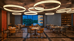 Grand Trunk restaurant seating area with circular pendant lighting at The Residency Signature Madurai.