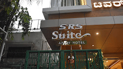 Facade of SRS Suites, Koramangala, featuring a signboard at the entrance of the hotel.