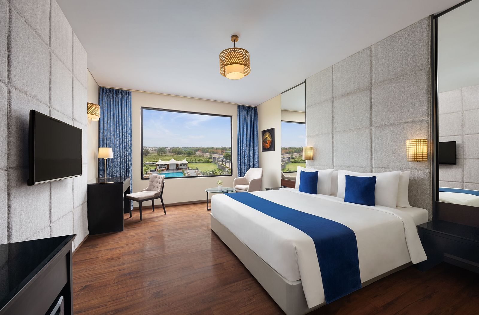 Premium Room at Essentia Luxury Hotel, Indore with a double bed, a television and work desk and chair