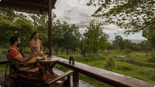 A couple enjoying a meal on the balcony of one of the rooms at The Serai Bandipur.