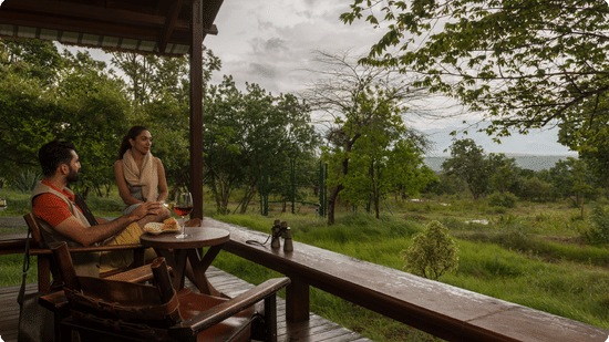A couple enjoying a meal on the balcony of one of the rooms at The Serai Bandipur.