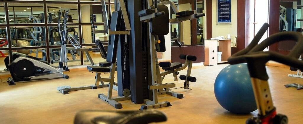 A gym filled with various equipment and bright lighting | Cenneys Gateway