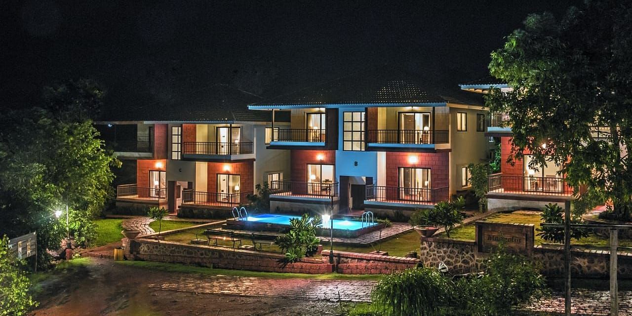 Facade view at night with lights glowing from the inside at Agreen Hotels & Resort.