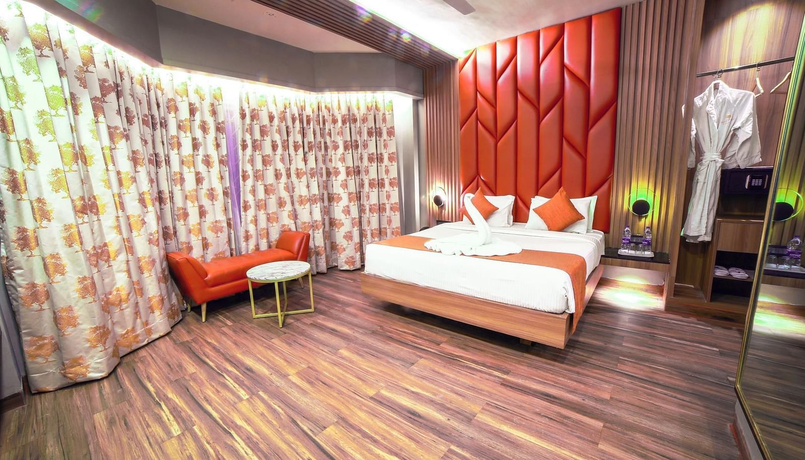 Front view of the double bed and chairs in the Junior Suite at Grand Palace, Yercaud