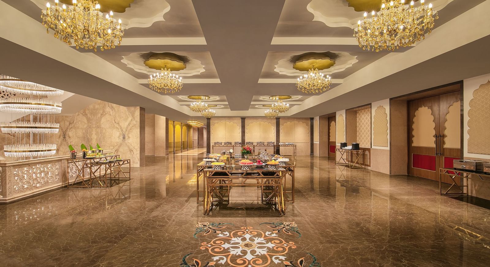 A banquet area with a long table, elegant decor, and chandeliers – Kaldan Samudra Palace, a stunning Luxury Marriage Hall ECR