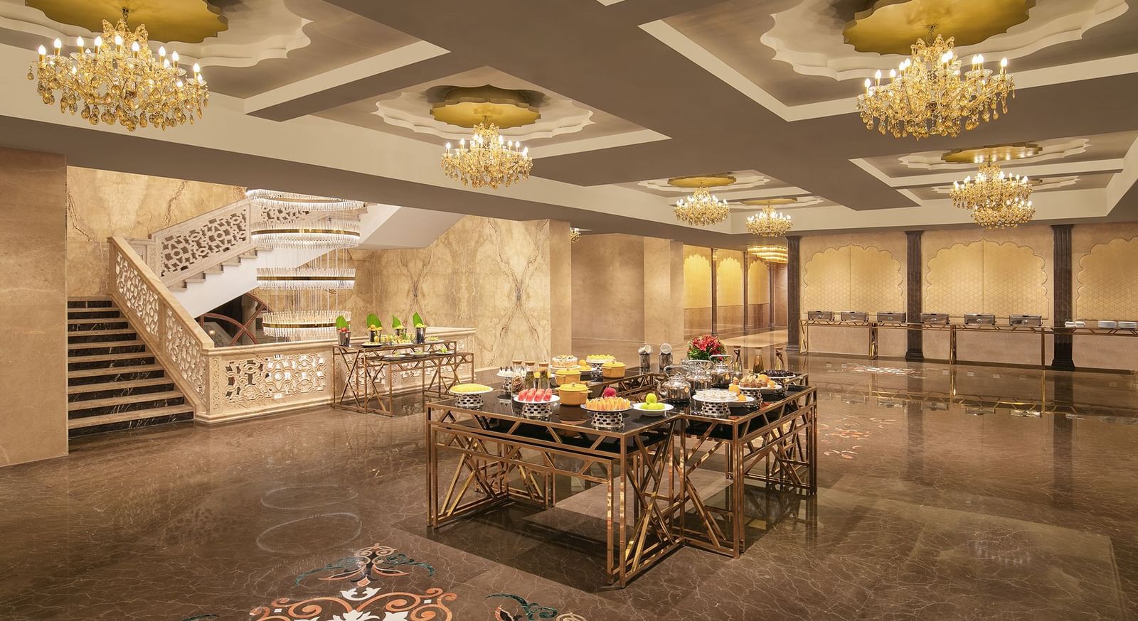 A banquet area with a table filled with foods placed under chandeliers – Kaldan Samudra Palace, one of the Best Banquet Halls in ECR