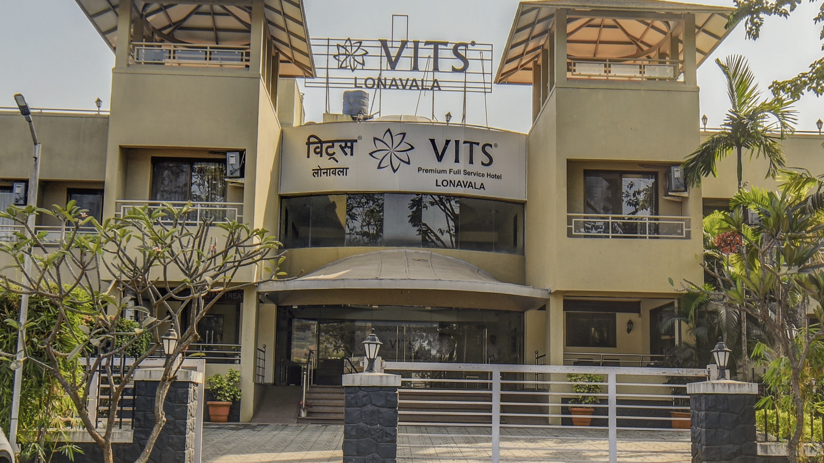 Close-up of hotel exterior signage and entrance gate at VITS Lonavala.