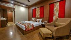 room with a commodious bed and cushy sofa