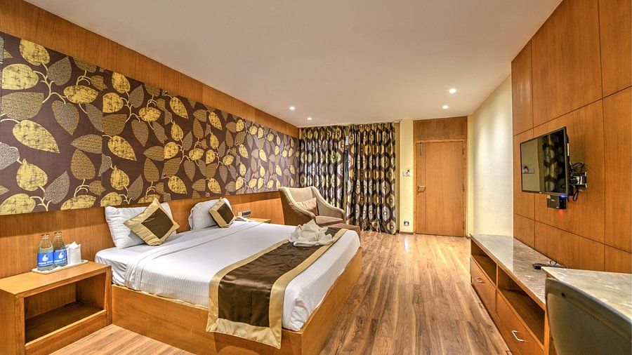 room with a commodious bed and cushy sofa