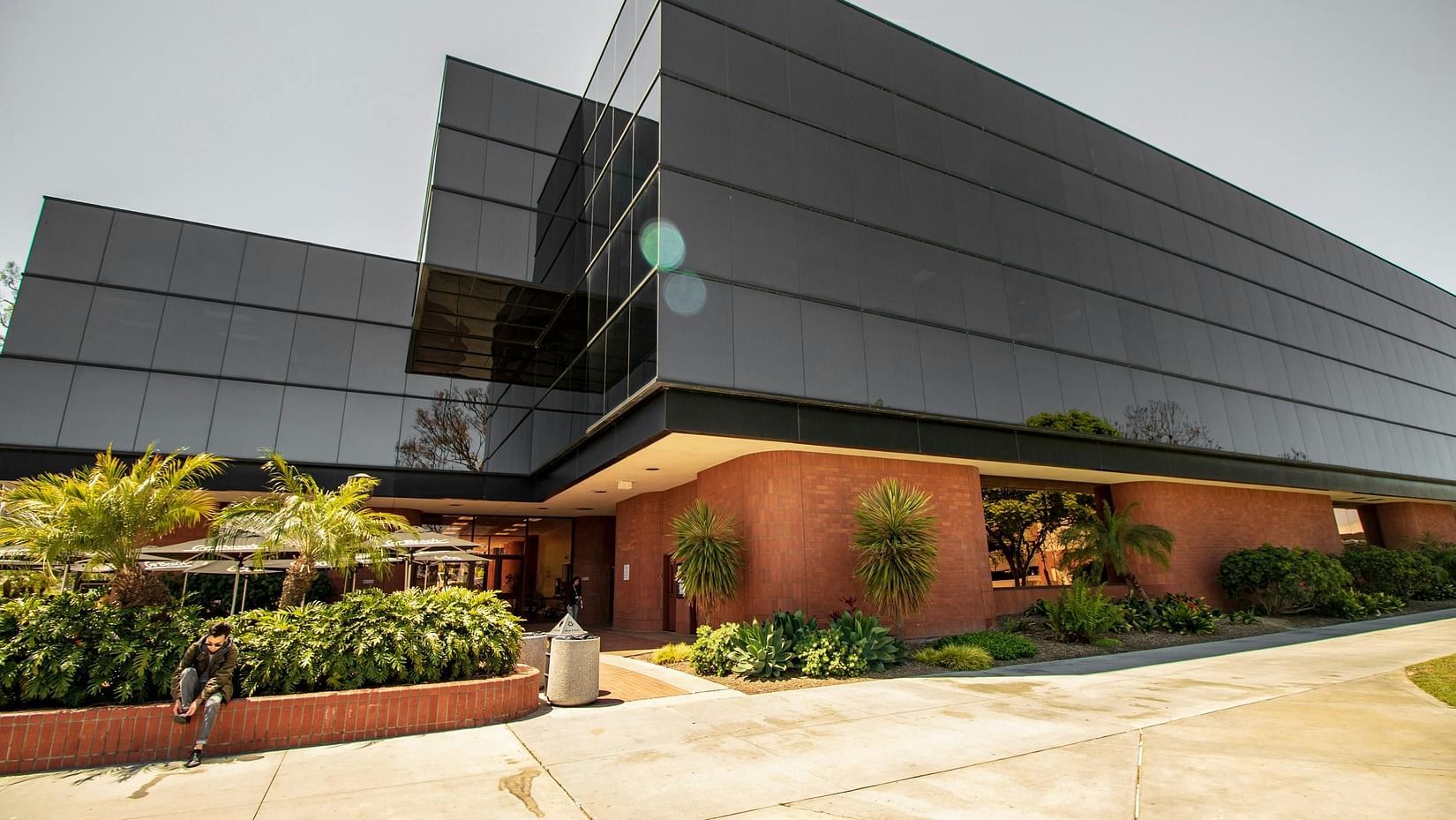 The exterior of a contemporary building, possibly the guest house or hotel, with sleek architecture.